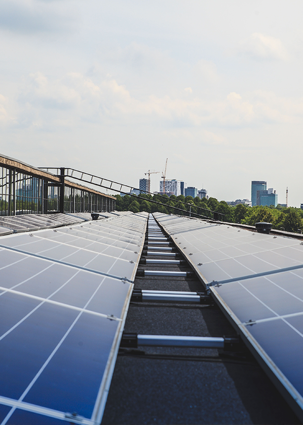 Image shows solar panels being installed on a commercial building